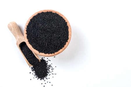 nigella seeds  in wooden bowl and scoop isolated on white backgroundの写真素材