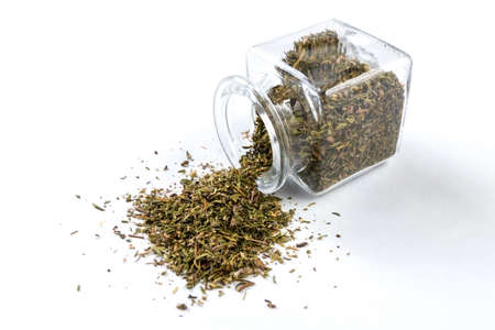 thyme herb in a glass jar isolated on white background