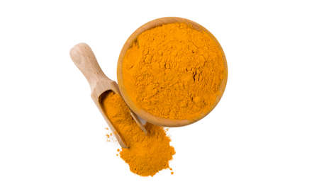turmeric powder in wooden bowl and scoop isolated on white background. top view. Spices and food...