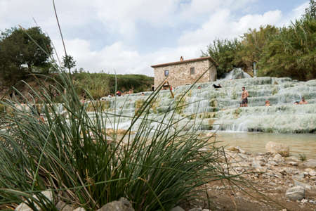 Saturnia, Grosseto / Italy 23 September 2019: Tourist bathing at Natural spa with waterfalls and hot springs Therme di Saturnia in Tuscany.のeditorial素材