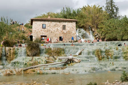 Saturnia, Grosseto / Italy 23 September 2019: Tourist bathing at Natural spa with waterfalls and hot springs Therme di Saturnia in Tuscany.のeditorial素材