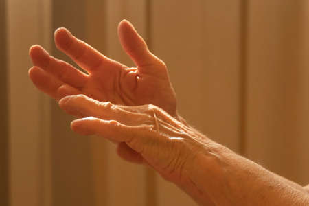 Older caucasian woman applying alcohol spray cleaning hands to helping protect from coronavirus covid-19の写真素材
