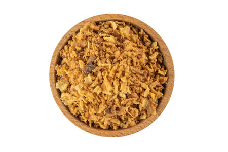 Crispy carmelized fried onion flakes in wooden bowl isolated on white background. Spices and food ingredients.の写真素材