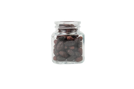 Dogwood or Cornel fruit herb used in herbal medicine in a glass jar isolated on white background. Herbs. Alternative medicine.の写真素材