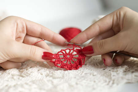 Crocheting a red flower pattern closeupの写真素材