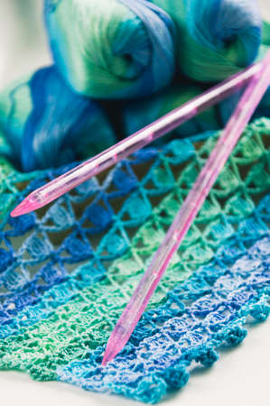 Knitting in blue and green tones with needles