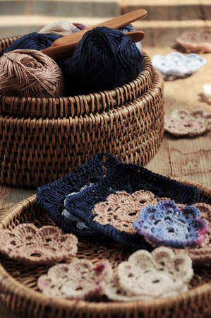 Box of yarn and handmade crocheted flowersの写真素材