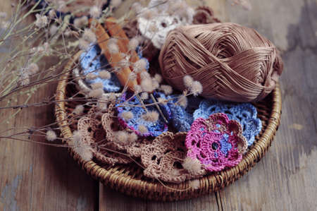 Box of yarn and handmade crocheted flowersの写真素材