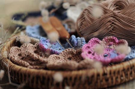 Box of yarn and handmade crocheted flowers