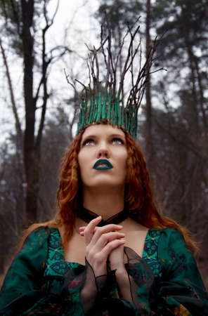 forest nymph in green dress prayingの写真素材