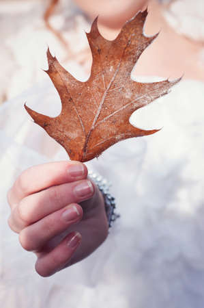 Girl holding an icy autumn leafの写真素材