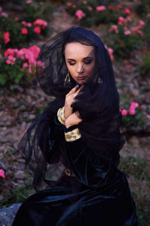 Young widow with closed eyes wearing black veilの写真素材