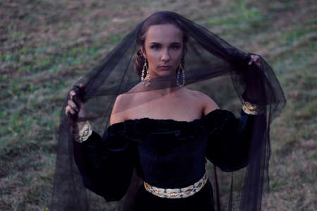 Young mysterious widow wearing black veilの写真素材