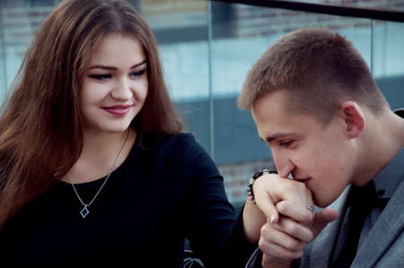 couple on a date in a cafe holding handsの写真素材
