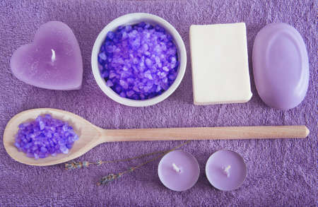 Lavender scented purple bath salt in a wooden spoon with soft purple towels. Spa and relax.の写真素材