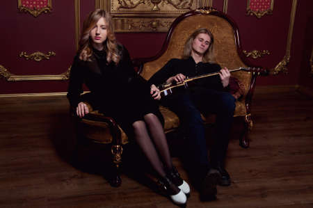 Handsome young couple of musicians boyfriend and girlfriend with blond hairの写真素材