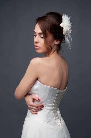 Elegant bride with brown short hair updo and bare shoulders white wedding dressの写真素材
