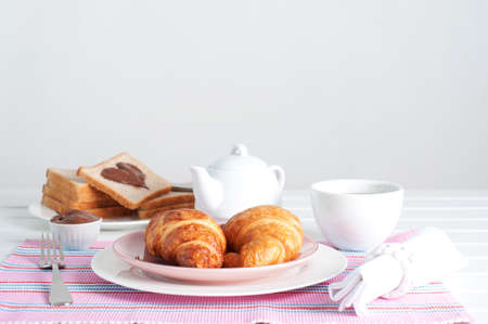 Sunday breakfast. Croissants with tea, toast and peanut butter.