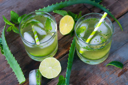 Aloe vera and lime cocktail with mint and ice cubes. Soft summer drinks.の写真素材