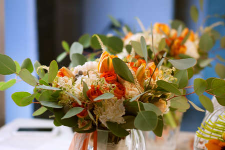 Spring flowers in the dressing room. Orange bouquet with carnations, tulips, roses and eucalyptus leaves.の写真素材
