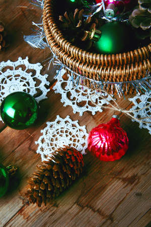 Vintage New year and Christmas decorations in woven basket with pine conesの写真素材