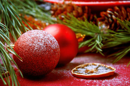 Christmas tree decoration red shiny and glitter balls on the table near the christmas treeの写真素材