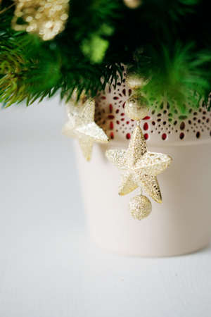Christmas holiday centerpiece decor with fir branches, golden leaves, red berries and white candle....
