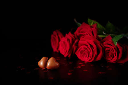 Valentine's Day celebration present chocolate heart candies and red roses symbol of love and passionの写真素材