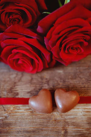 Valentine's Day celebration present chocolate heart candies and red roses symbol of love and passionの写真素材