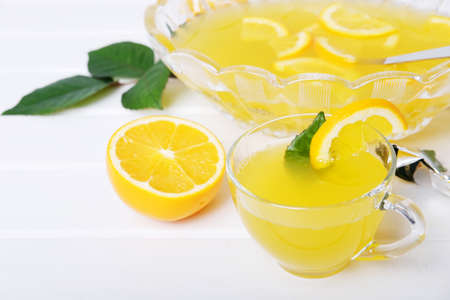 Lemon punch with pieces of fruit sweet alcohol summer drinkの写真素材