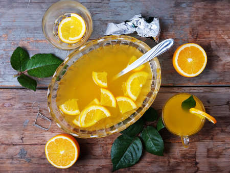 Orange punch with pieces of fruit sweet alcohol summer drinkの写真素材