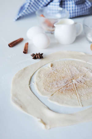 Cooking stages. Preparing dough for pies fresh eggs, flour and milk ingredients on table.の写真素材