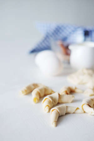 Cooking stages. Preparing dough for pies fresh eggs, flour and milk ingredients on table.の写真素材