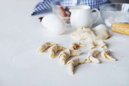 Cooking stages. Preparing dough for pies fresh eggs, flour and milk ingredients on table.の写真素材