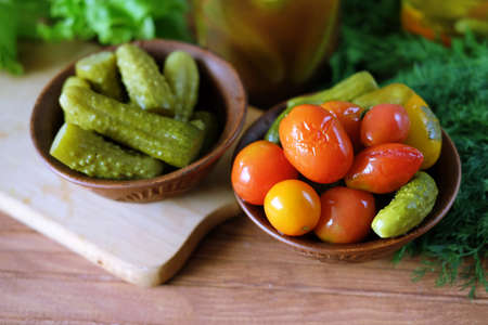 Homemade pickled vegetables. Tomatoes and cucumbers pickles from the bottle.の写真素材