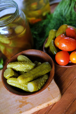 Homemade pickled vegetables. Tomatoes and cucumbers pickles from the bottle.の写真素材