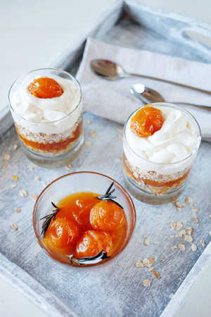 Oats layered with spicy and sweet apricot jam and cream served for breakfast. Healthy food concept.の写真素材