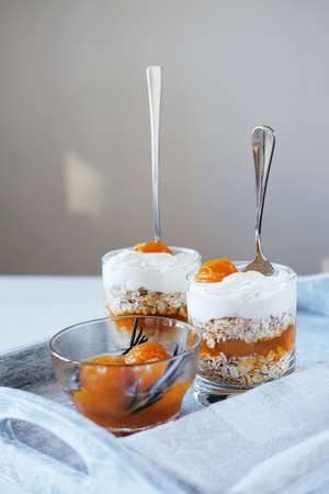 Oats layered with spicy and sweet apricot jam and cream served for breakfast. Healthy food concept.の写真素材