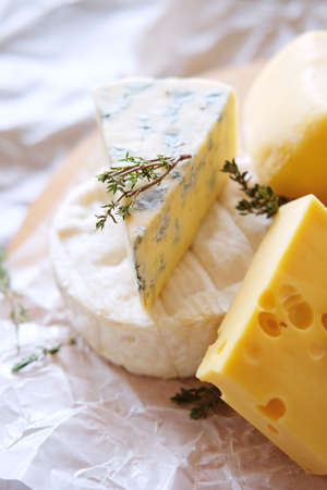 Cheese plate with different kinds of cheese with baguette