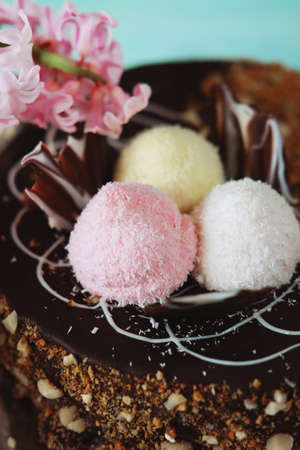 Holiday meal concept. Sweet chocolate cake with peanuts, shredded coconut flakes and tea.