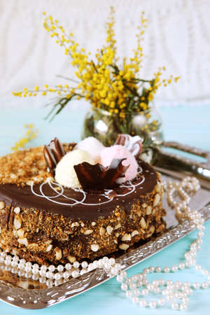 Holiday meal concept. Sweet chocolate cake with peanuts, shredded coconut flakes and tea.