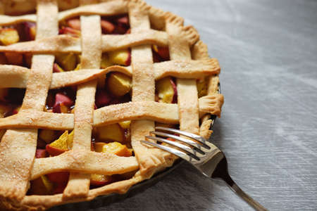Peach filling for tasty summer fruit pie with chopped peaches in water-logged dough
