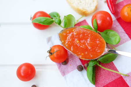 Hot and spicy tomato sauce made of vegetables, pepper and herbs. Adjika.