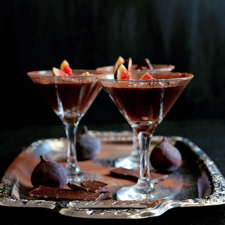 Chocolate mousse dessert with cinnamon, walnuts and figs served in cocktail glassの写真素材