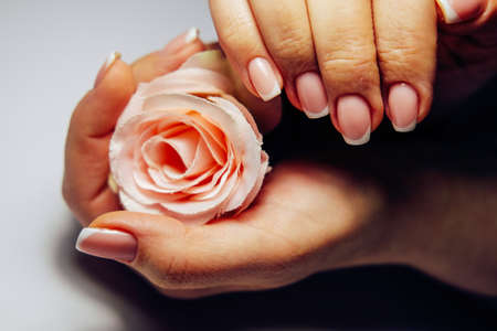 French nail extensions. Women at beauty parlour doing classic manicure.の写真素材