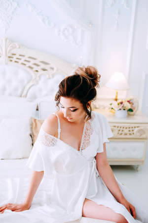 Beautiful young bride in honeymoon suite getting ready for the weddingの写真素材