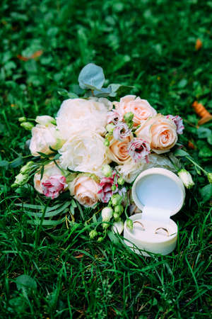 Wedding symbols and accessories. Bridal bouquet and wedding rings.の写真素材
