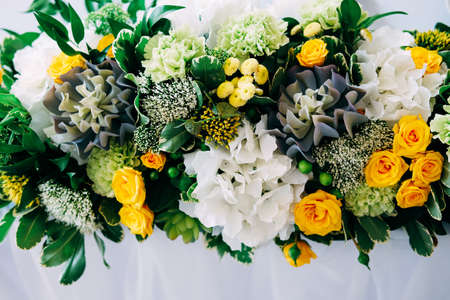 Elegant table setting for the wedding  with candlestick centerpiece in yellow and green colorsの写真素材