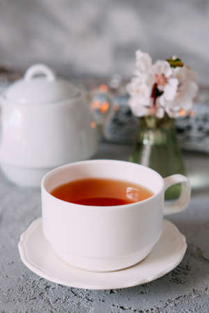 English breakfast. Tea in a white cup and a teapot served with brownies.の写真素材
