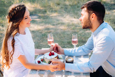 Couple of lovers on a date celebrating their engagement at the dinner table outdoors - Italian restaurant terasseの写真素材
